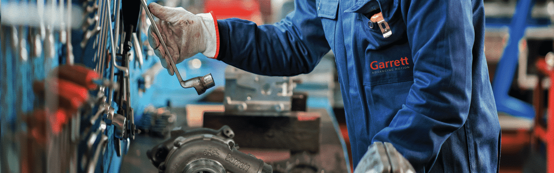 Mechanic in a garage choosing a wrench