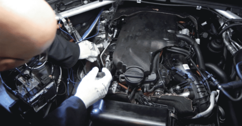 Mechanic fixing on car with a turbocharging failure